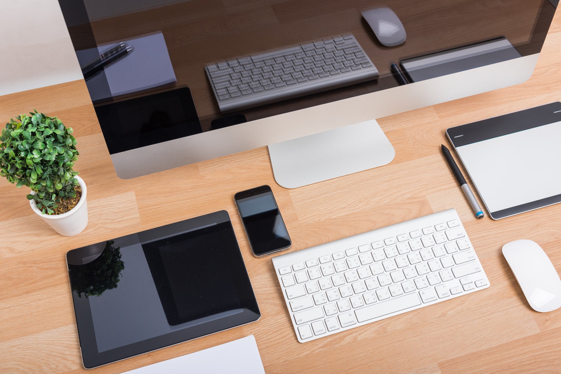 various computer devices on a work desk